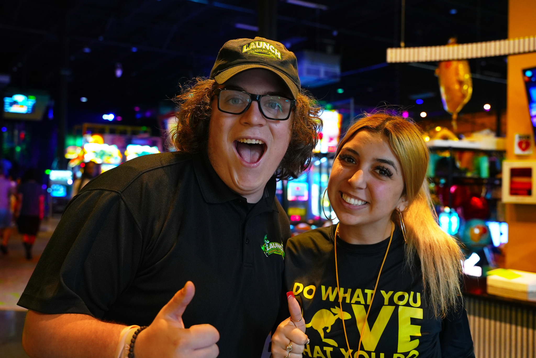 Launch team members smiling in the arcade